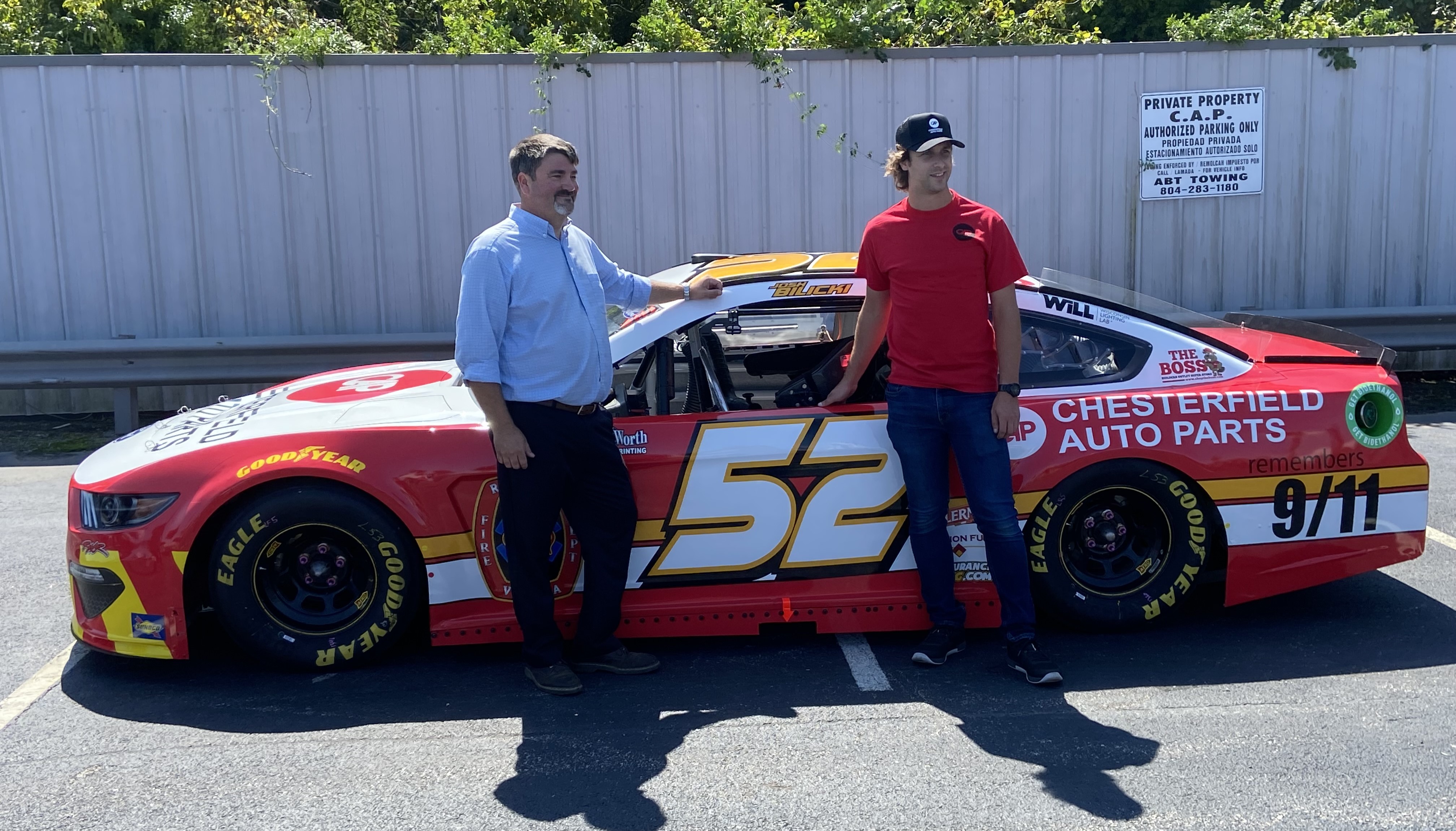 Chesterfield Auto Parts Owner Troy Webber stands with NASCAR driver Josh Bilicki in front
              of the #52 Chesterfield Auto Parts Ford Mustang